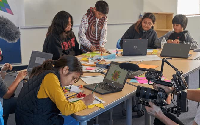 Students working at a table in a classroom